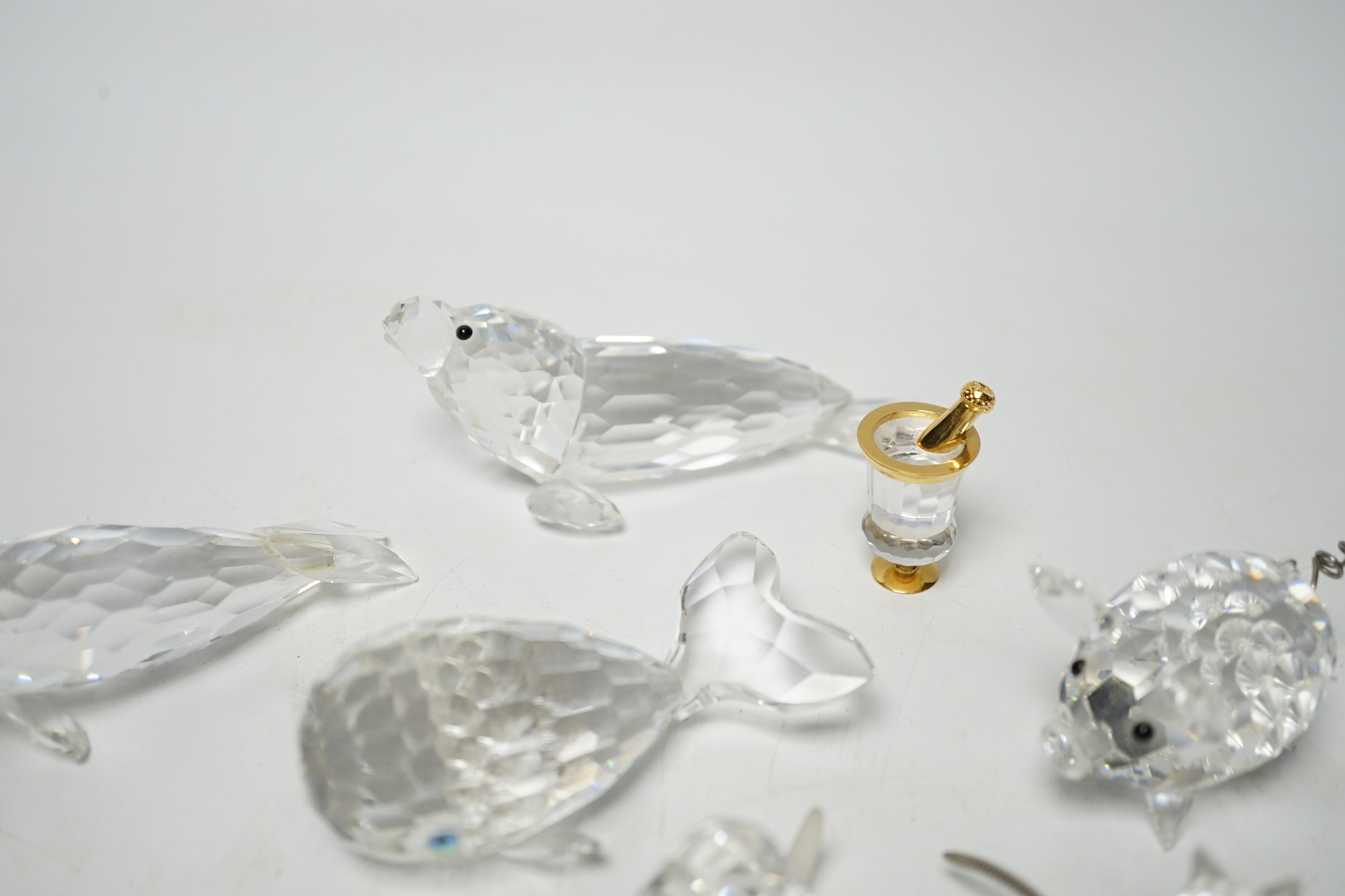 Eight Swarovski crystal animal ornaments and a miniature set of a Champagne cooler and two Champagne glass flutes, (11)